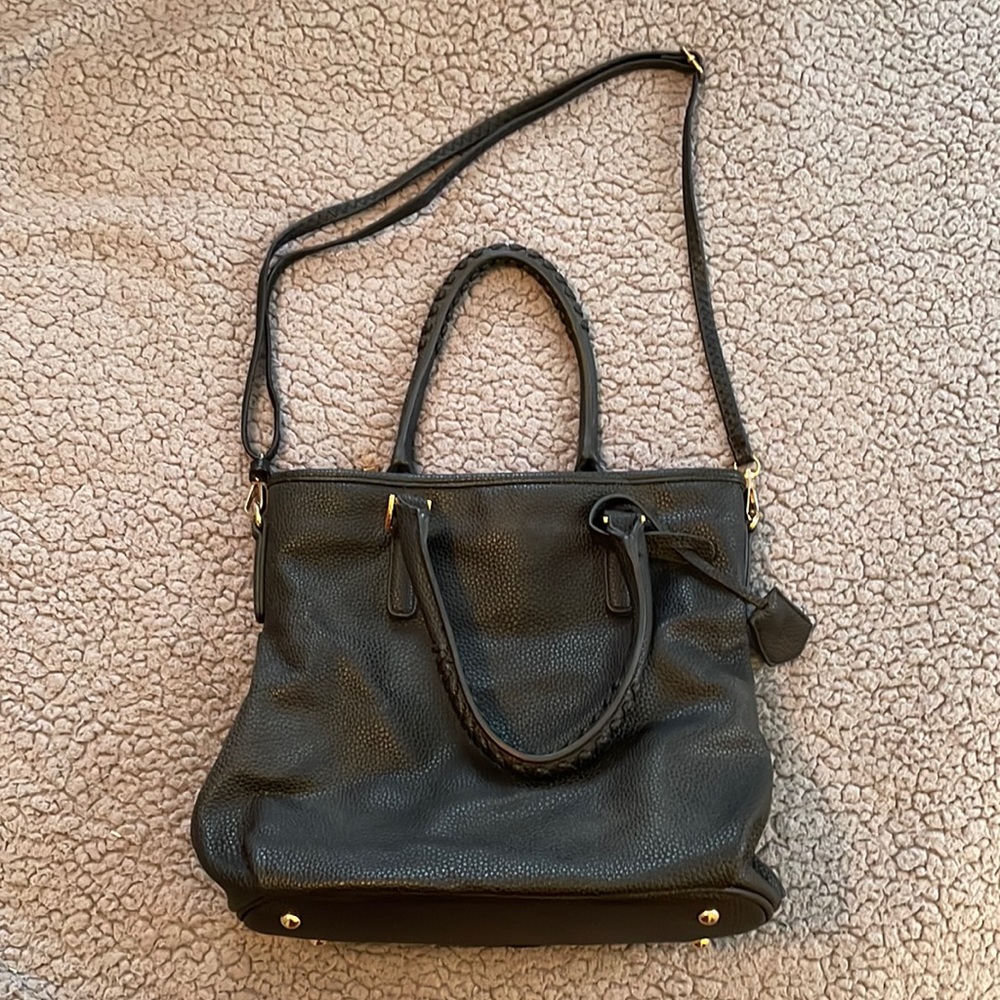 Black leather detailed shoulder bag with detailed handles & gold accents.